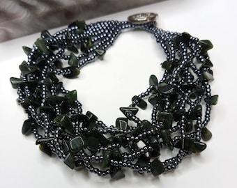 Dark serpentine chip beaded bohemian style bracelet with hematite colored seed beads and silver celtic knot button