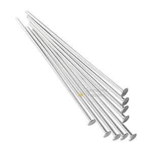 May include: A pack of 12 silver head pins, each with a flat, round head. The pins are arranged in a fan shape, with the heads facing the viewer.