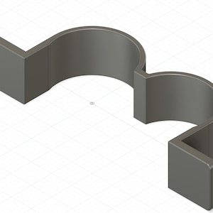 May include: A gray plastic 3D printed object with two curved sections and two square ends. The object is designed to hold two items.