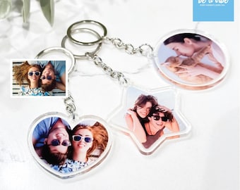 May include: Three clear acrylic keychains with different shapes: a heart, a star, and a circle. Each keychain features a photo of a couple. The text "be a vibe" is printed on a blue background in the top right corner of the image.