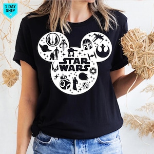 May include: Black t-shirt featuring a white Mickey Mouse silhouette filled with Star Wars characters and the text "STAR WARS".