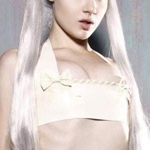 Latex lingerie Bow and ruffle halter neck bra in white.