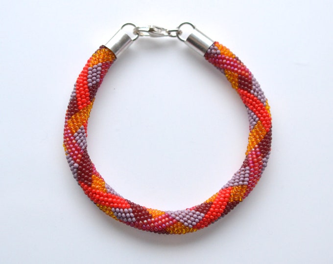 bracelet beaded braiding ornament red tones silver closure