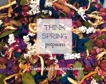 May include: A close-up of a colorful potpourri mix with dried flowers, leaves, and citrus peels. The text "Think Spring potpourri" is superimposed on the image.