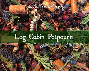 May include: A close-up of a brown, green, and red potpourri mix. The mix includes cinnamon sticks, pine cones, and dried berries. The text "Log Cabin Potpourri" is displayed on a green banner.