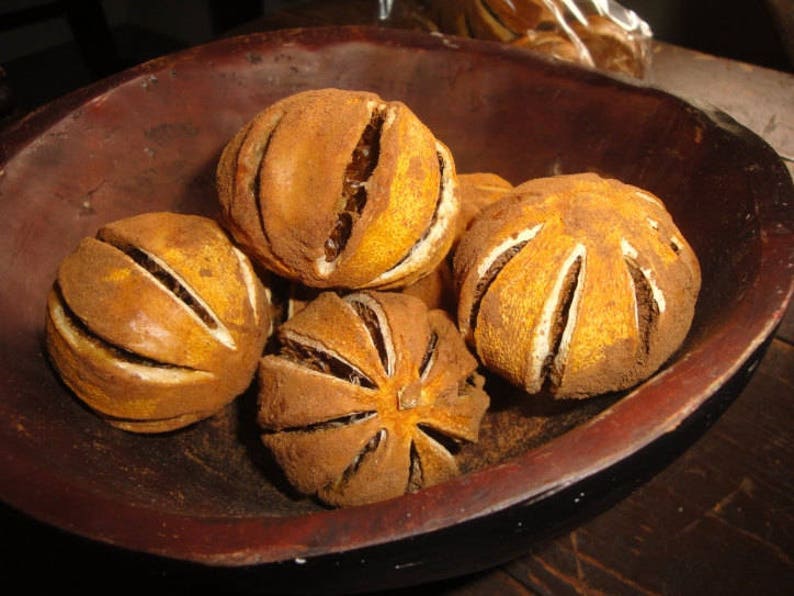 Whole dried Orange Pomanders partially dipped in Certified