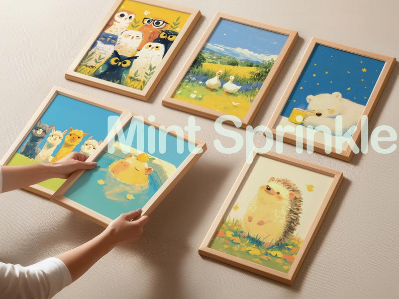 May include: Five framed rectangular wall art prints featuring colorful illustrations of owls, ducks in a field, a polar bear, a group of llamas, a capybara in water, and a hedgehog, all enclosed in light-colored wooden frames with the text Mint Sprinkle.