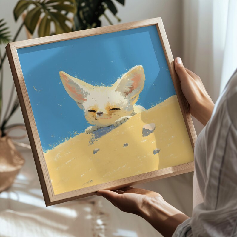 May include: A framed illustration of a white fennec fox with large ears peeking out from behind a sand dune. The fox has a happy expression and is looking towards the viewer. The background is a light blue sky.