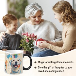 May include: A white ceramic mug with a black handle features a colourful watercolour design of a dog with the name "bella" written on the mug. The mug is sitting on a table with a bouquet of pink roses and a gift box in the background.
