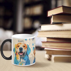 May include: White ceramic coffee mug with a black handle. The mug features a colourful illustration of a golden retriever dog with the name "Cooper" printed on the mug.
