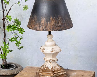 May include: A distressed black lampshade with a white and brown wooden base. The lamp has a rustic farmhouse style.