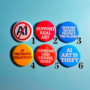 May include: A collection of six round buttons with text and graphics. The buttons are red, blue, and yellow, with white text. The text includes phrases like "Support Real Art" and "AI Destroys Creativity."