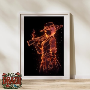 May include: A framed art print with a neon orange illustration of a person in a cowboy hat holding a rifle. The artwork is set against a black background, with a white frame. The print has a western theme.