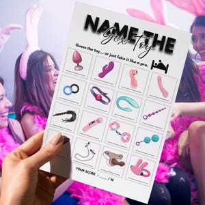 May include: A game card titled "NAME THE Sex Toy" with illustrations of various adult toys. The card is held by a person, with three women in the background wearing pink feather boas and bunny ears.