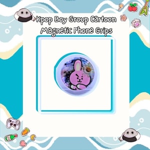 May include: A circular magnetic phone grip featuring a cartoon pink rabbit character with a winking expression, set against a background of blue and purple swirls with a small white daisy flower. The text Kpop Boy Group Cartoon Magnetic Phone Grips is visible.