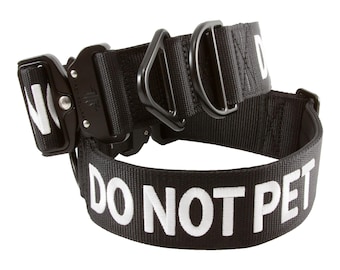 May include: Black nylon dog collar with a black metal buckle and the words "DO NOT PET" in white lettering.