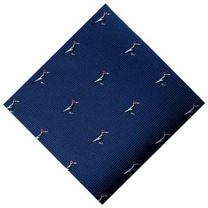 May include: A navy blue tie featuring a repeating pattern of stylized woodpeckers. Each bird is depicted in black and white with a red head, set against a textured background. The tie is angled, showcasing its design.