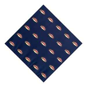 May include: A square navy blue fabric featuring a repeating pattern of small, stylized Venus flytrap plants. Each plant is depicted with a red interior, yellow edges, and dark brown spiky cilia, arranged in a consistent grid across the dark blue surface.