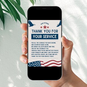 May include: A digital phone screen displaying a thank you card for veterans. The card features a blue and red American flag with stars and the text "DEAR VETERAN THANK YOU FOR YOUR SERVICE". The text below the flag reads "FOR ALL THE COURAGE YOU HAVE SHOWN, AND SACRIFICES MADE ALONE, WE HONOR YOU, BOTH BRAVE AND TRUE, THIS DAY WE CELEBRATE YOU. THROUGH TRIALS FACED AND BATTLES FOUGHT, YOUR STRENGTH AND SPIRIT CAN'T BE BOUGHT WITH GRATEFUL HEARTS, WE STAND AND SAY, THANK YOU FOR YOUR SERVICE TODAY."