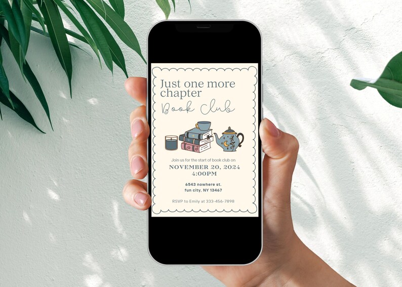May include: A smartphone displaying a book club invitation with the text "Just one more chapter Book Club" and details for a meeting on November 20, 2024 at 4:00 PM. The invitation features illustrations of a teapot, books, and a candle.