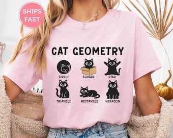 May include: A light pink t-shirt with the words "CAT GEOMETRY" in black. Below the text are black cat illustrations inside of geometric shapes: circle, square, star, triangle, rectangle, and hexagon.