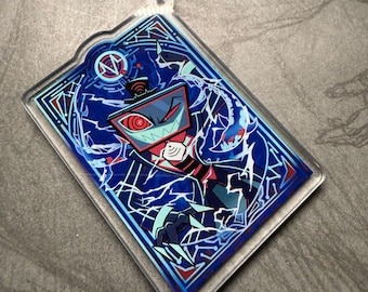 May include: A rectangular acrylic keyring with a character design. The design is predominantly blue, red, and white, featuring a detailed illustration of a character with a television-like head. The keyring has a silver chain and clasp.
