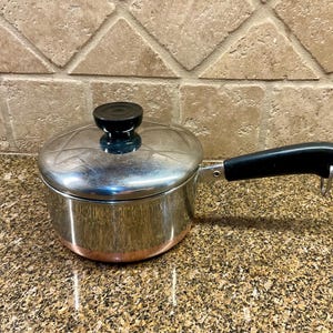 May include: A set of three ceramic mugs with a speckled, matte finish. The mugs are in shades of cream, light gray, and dark gray. Each mug has a simple, minimalist design, perfect for coffee or tea.