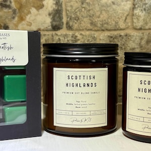 May include: An image of a candle and wax melts set. The candle jars are brown with black lids and labels that read "Scottish Highlands." The wax melts are green and in a black box with the same label.
