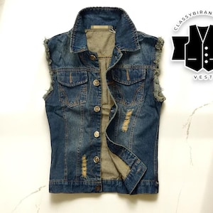 May include: A sleeveless denim vest in a medium wash blue, featuring a classic collar, button-up front, and two chest pockets. The vest has distressed details and a faded appearance. The image includes a logo that says "ClassyBiranstyles VEST".