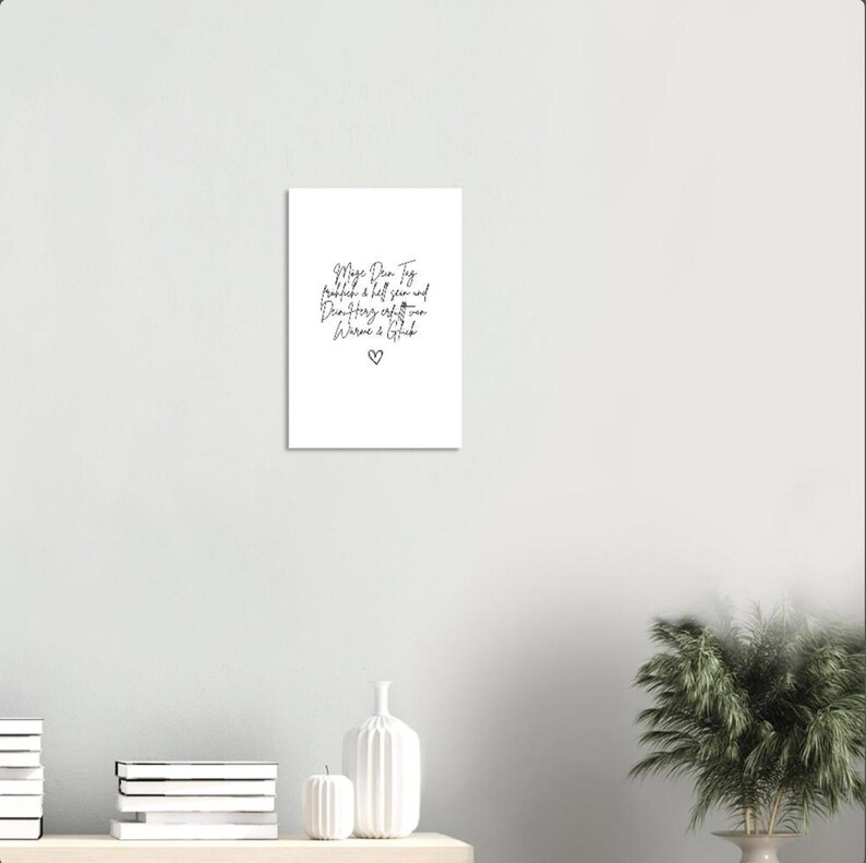 May include: A white card with black handwritten text that reads "Maya Dear Tag,  probably a bit late and definitely off-key, but here is a gift". A small heart is drawn at the bottom of the card.