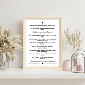 May include: A black and white printable poster with a motivational quote in German. The quote is about self-love and acceptance. The poster is framed and hanging on a white wall.
