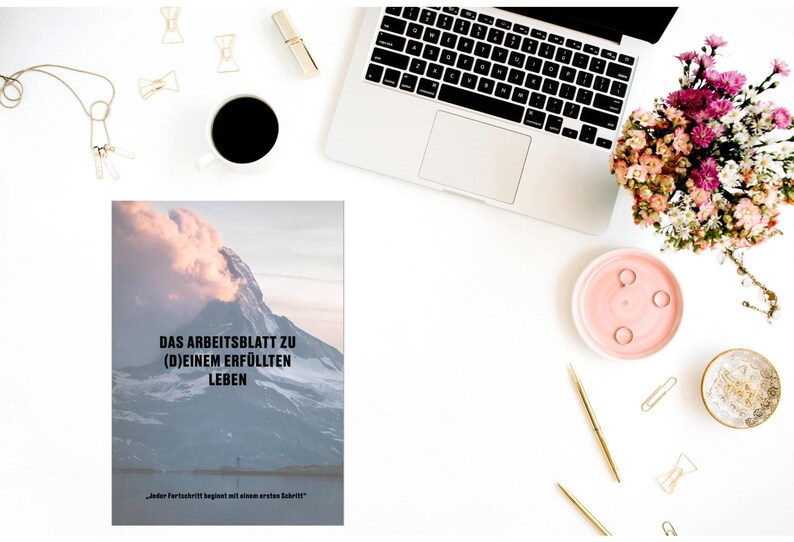 May include: A motivational worksheet with a mountain range background. The text reads "Das Arbeitsblatt zu (D)einem Erf&uuml;llten Leben" and "Jeder Fortschritt beginnt mit einem ersten Schritt".