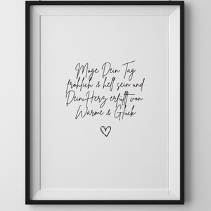 May include: Black and white framed print with the text "M&ouml;ge Dein Tag fr&ouml;hlich & hell sein und Dein Herz erf&uuml;llt von W&auml;rme & Gl&uuml;ck" and a small heart symbol.