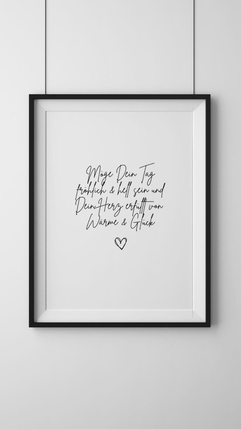 May include: Black and white framed print with the text "M&ouml;ge Dein Tag fr&ouml;hlich & hell sein und Dein Herz erf&uuml;llt von W&auml;rme & Gl&uuml;ck" and a small heart symbol.