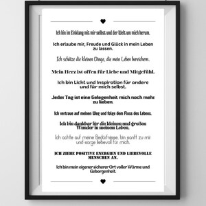 May include: A framed print with black frame. The white paper has black text in German, with phrases about self-love and positivity. The print is a motivational piece.