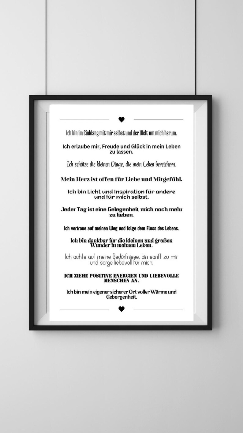 May include: A framed print with black frame. The white paper has black text in German, with phrases about self-love and positivity. The print is a motivational piece.