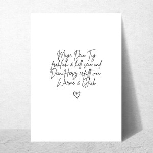 May include: A white card with black calligraphy that reads "May your day be happy and bright and your heart filled with warmth and happiness." A small black heart is at the bottom of the card.