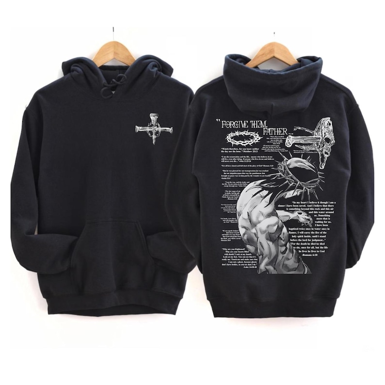 May include: Black hoodie with a front pocket and a white graphic of a cross made of nails. The back of the hoodie features a detailed illustration with the text "FORGIVE HIM, FATHER..." and a depiction of a crown of thorns.