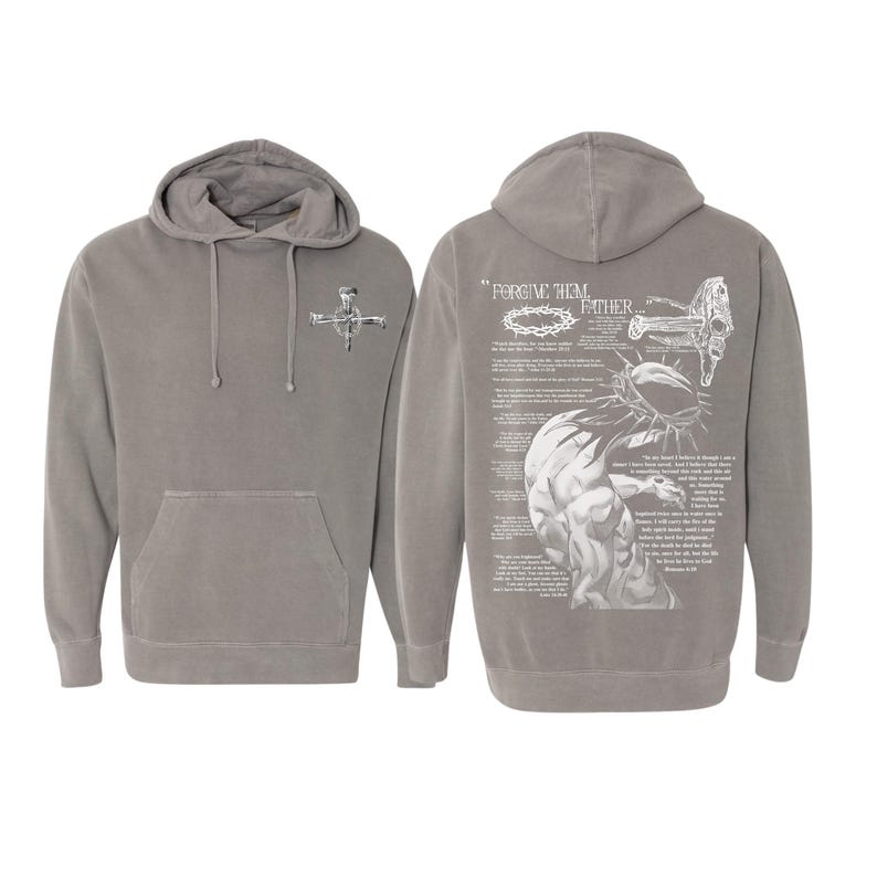 May include: Gray hoodie with a front pocket and a hood. The front features a small graphic of a cross. The back displays a detailed illustration with the text "FORGIVE THEM FATHER" and religious imagery.
