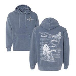 May include: A blue-grey hoodie with a front pocket and a hood. The front features a small cross design. The back displays a detailed graphic with the text "FORGIVE THEM FATHER" and a depiction of a crown of thorns and a figure.
