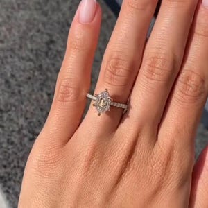 Stunning 2 carat hexagon cut lab grown diamond ring with a hidden halo, handcrafted in solid 14K gold. Modern and ethical engagement ring featuring a moissanite wedding band for added sparkle. Ideal for proposals, anniversaries, or as a unique promise ring. Sleek, geometric design for the contemporary bride. Sustainable and luxurious fine jewelry gift for her, available in rose, white, or yellow gold.