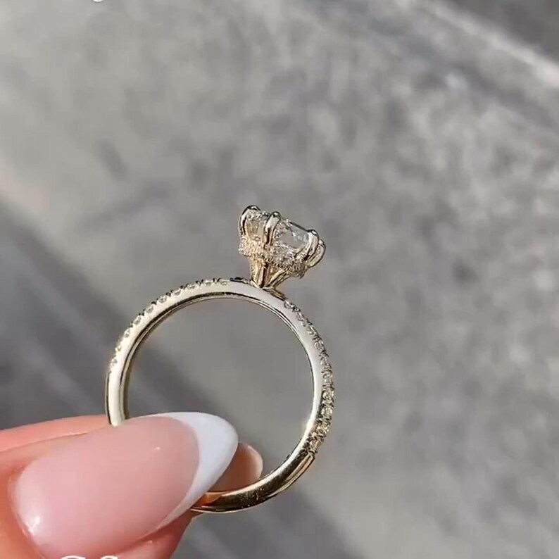 Stunning 2 carat hexagon cut lab grown diamond ring with a hidden halo, handcrafted in solid 14K gold. Modern and ethical engagement ring featuring a moissanite wedding band for added sparkle. Ideal for proposals, anniversaries, or as a unique promise ring. Sleek, geometric design for the contemporary bride. Sustainable and luxurious fine jewelry gift for her, available in rose, white, or yellow gold.