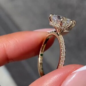 Stunning 2 carat hexagon cut lab grown diamond ring with a hidden halo, handcrafted in solid 14K gold. Modern and ethical engagement ring featuring a moissanite wedding band for added sparkle. Ideal for proposals, anniversaries, or as a unique promise ring. Sleek, geometric design for the contemporary bride. Sustainable and luxurious fine jewelry gift for her, available in rose, white, or yellow gold.