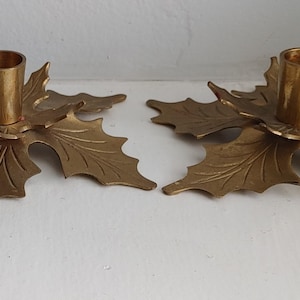2 Vintage Brass candle holders in the shape of holly that are classic and fit with any decor glowing brass very elegant design