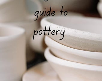 May include: A close-up of a stack of white ceramic bowls and plates. The text "A beginners guide to pottery" is written in black cursive on top of the image.