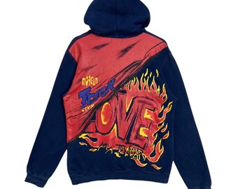 May include: Navy blue hoodie with a red and black graphic design. The back features the word "LOVE" in a flame-like font, with the words "Morgan Trash" above it. The hoodie has a hood and long sleeves.