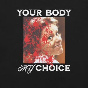 May include: A black and white graphic design with a woman's face covered in red splatter. The text "YOUR BODY MY CHOICE" is written in white letters.
