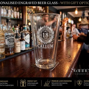 May include: A clear conical pint glass featuring a laser-engraved circular emblem with the text "LIMITED EDITION", "18 YEARS", "AGED TO PERFECTION", and the name "CALLUM" centered below the design, set against a dark wooden bar background.