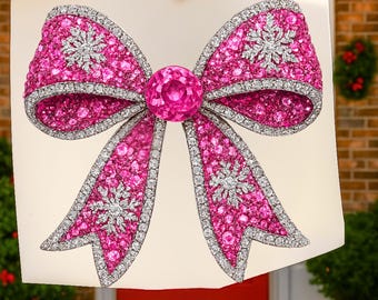 May include: A large, ornate bow illustration with a vibrant pink hue, embellished with sparkling white accents. The bow features a central pink gemstone and is held against a neutral background. The design incorporates snowflake-like patterns.