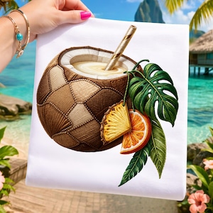 May include: White fabric with a detailed illustration of a coconut cocktail. The drink has a straw, and is decorated with pineapple, orange slices, and green leaves. The coconut is brown and beige, with a stitched appearance.